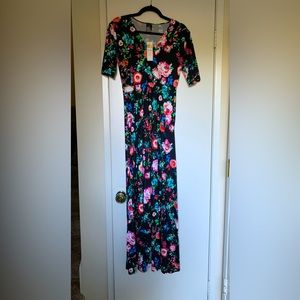 Agnes & Dora Essential Austen Maxi Dress in Floral print. Black Background.
